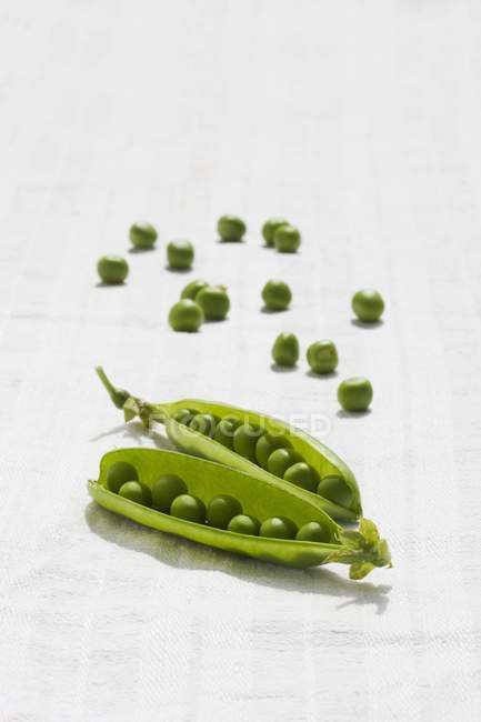 Fresh green pods and peas — Stock Photo