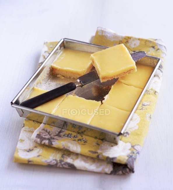 Closeup view of lemon pie slices in a baking tin — Stock Photo