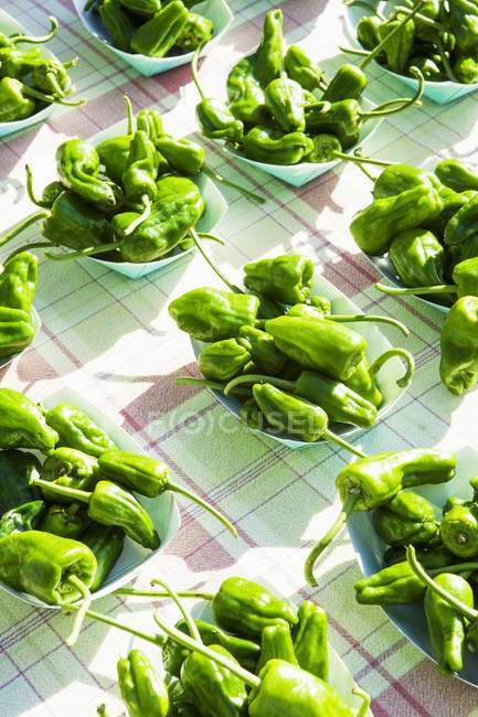 Green peppers in bowls — Stock Photo