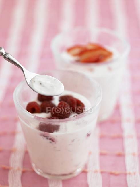 Glass of yoghurt with raspberries — Stock Photo