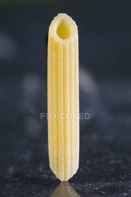 Piece of fresh penne rigate pasta — Stock Photo