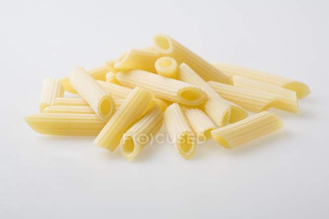 Pile of fresh Penne Rigate pasta — Stock Photo