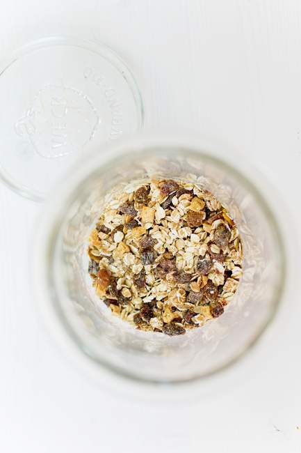 Muesli with raisins in glass — Stock Photo