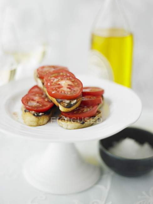 Grilled bread topped with tomatoes — Stock Photo