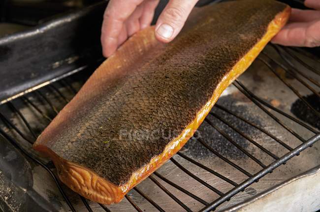Smoked salmon fillet on cooling rack — Stock Photo