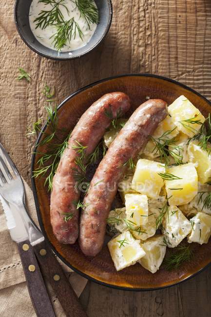 Sausages with potato salad and dill — Stock Photo