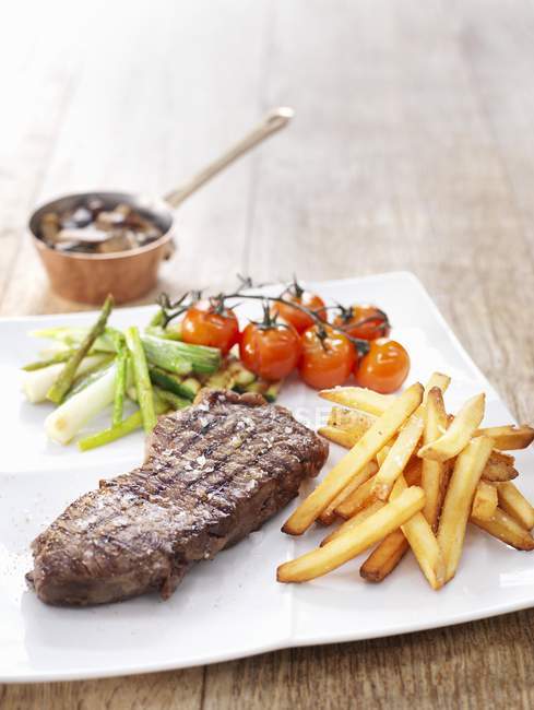 Grilled steak with chips — Stock Photo