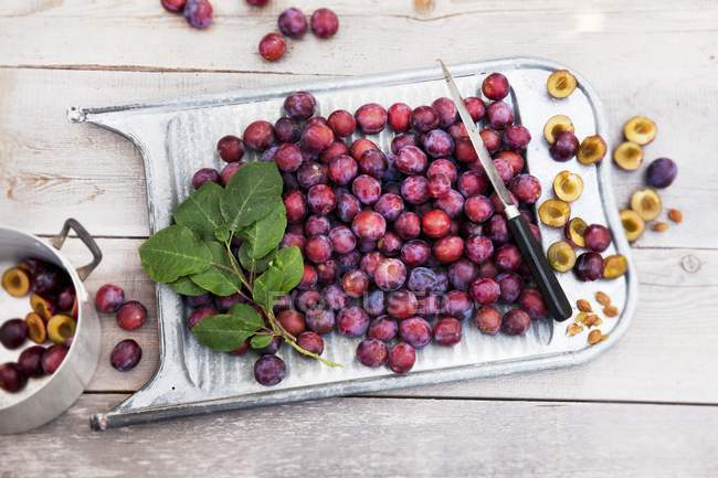 Fresh picked damsons on old washboard — Stock Photo