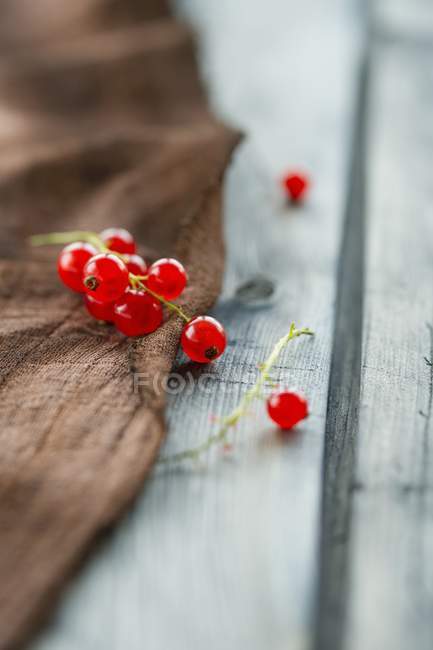 Groselhas vermelhas em tecido marrom — Fotografia de Stock