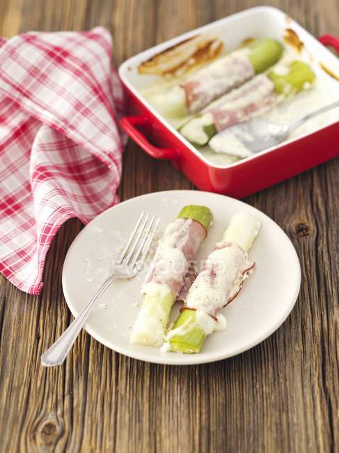 Baked leek wrapped in ham — Stock Photo
