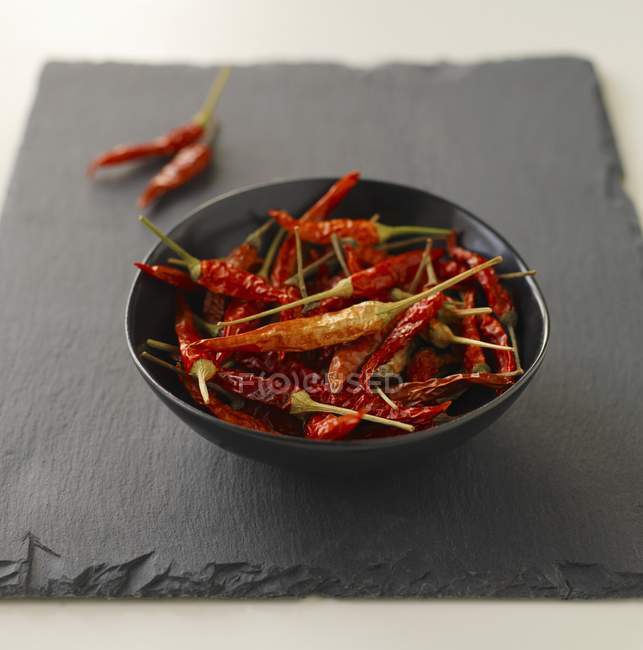 Dried chillis in bowl — Stock Photo