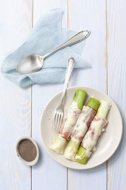 Baked leek wrapped in ham — Stock Photo