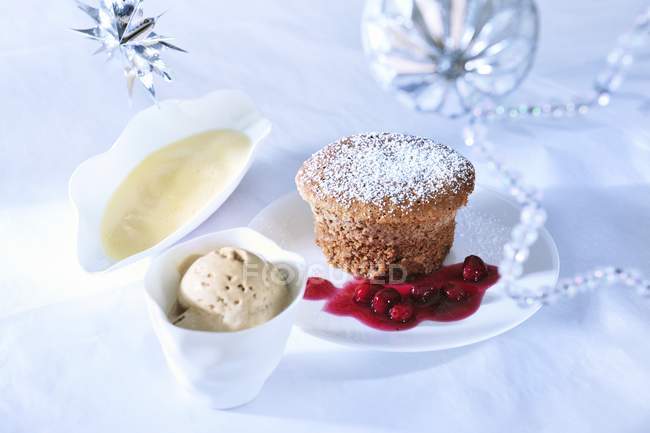 Closeup view of chocolate souffle with ice cream and berry sauce — Stock Photo