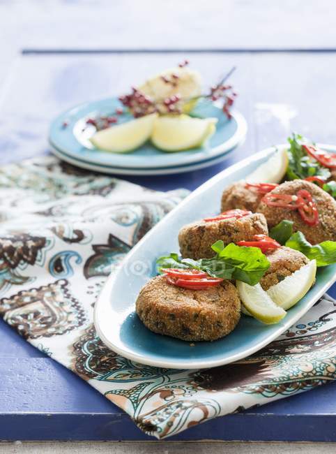 Salmon burgers with lemons and peppers — Stock Photo