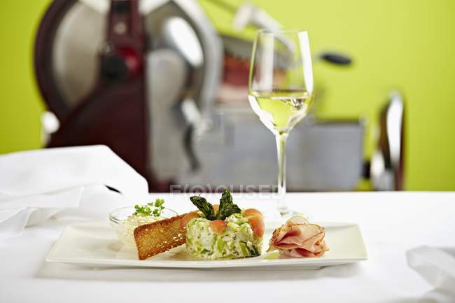 Салат из зеленой спаржи с белой тарелкой на столе из стекла — стоковое фото