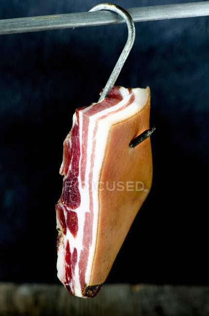 Closeup view of meat piece with fat hanging on hook — Stock Photo