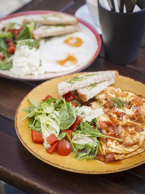 Крупный план блинов с салатом, яичницей и тостами — стоковое фото