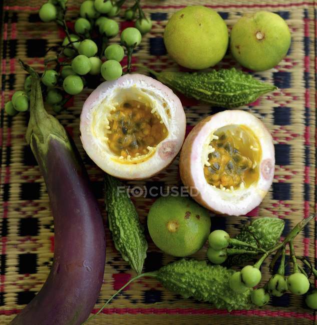Aubergine with bitter gourds and passion fruit — Stock Photo
