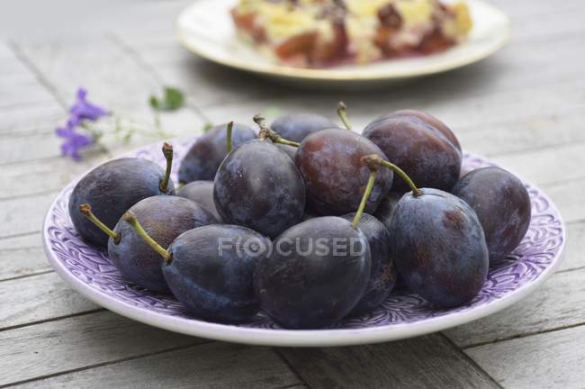 Fresh plums on plate — Stock Photo