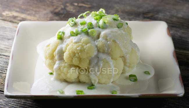 Cauliflower with a white sauce on plate — Stock Photo