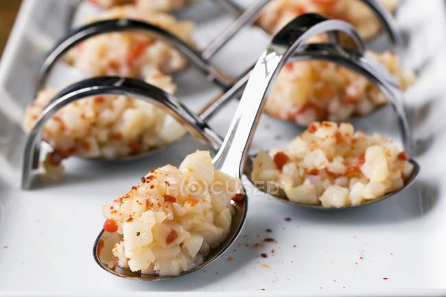 Closeup view of scallop Tartar with truffle oil on metal spoons — Stock Photo