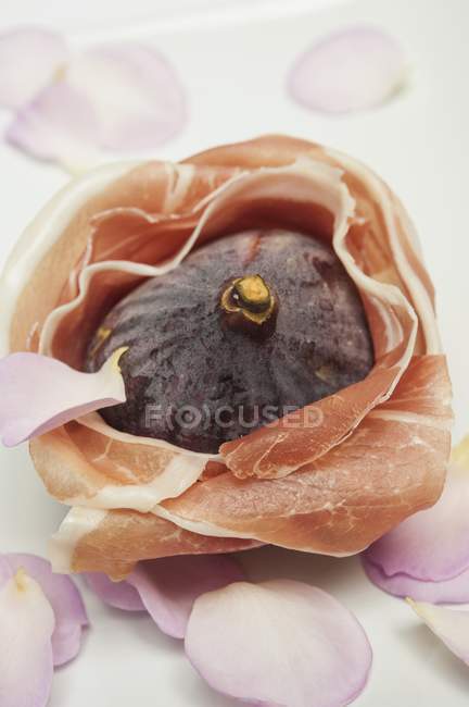 Fig wrapped in Parma ham — Stock Photo