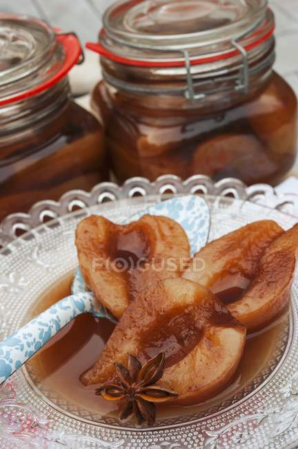 Closeup view of pears in cherry brandy with star anise — Stock Photo