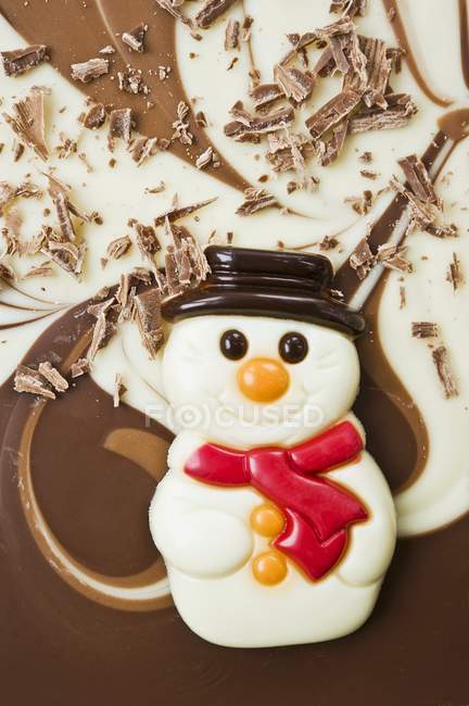 Closeup view of chocolate snowman and crumbles — Stock Photo