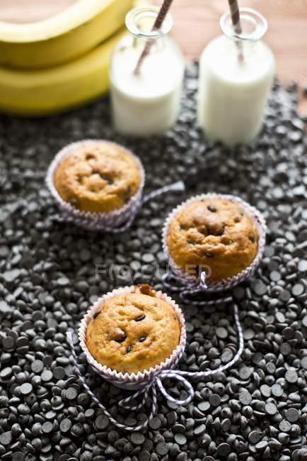 Muffins with bottles of milk — Stock Photo
