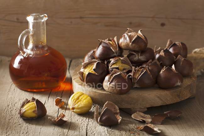 Roasted chestnuts and sea buckthorn syrup — Stock Photo