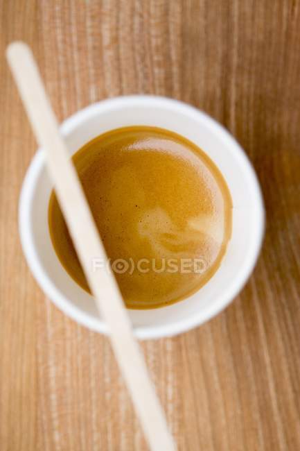 Espresso cup with wooden stick — Stock Photo