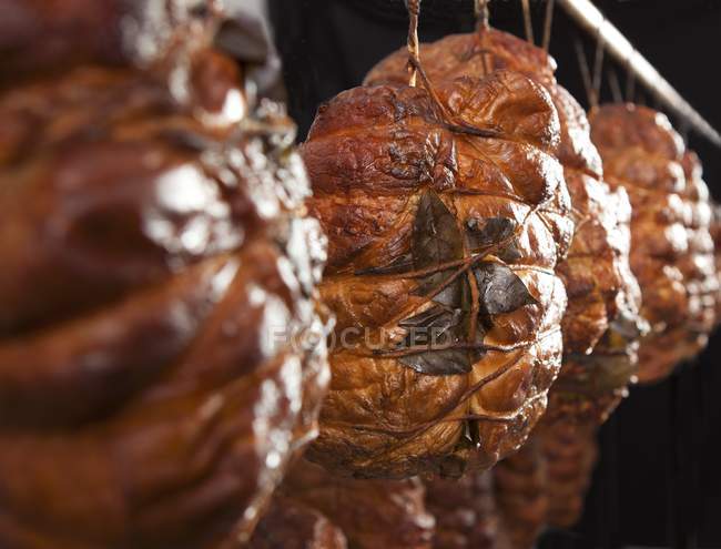 Smoked ham hanging — Stock Photo