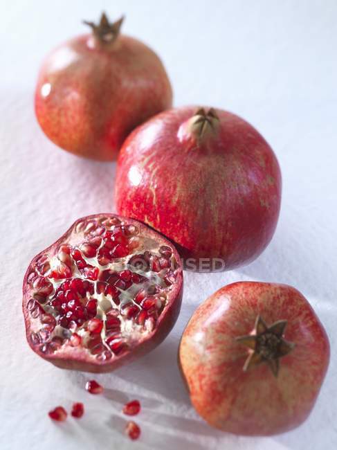 Fresh pomegranates with half — Stock Photo
