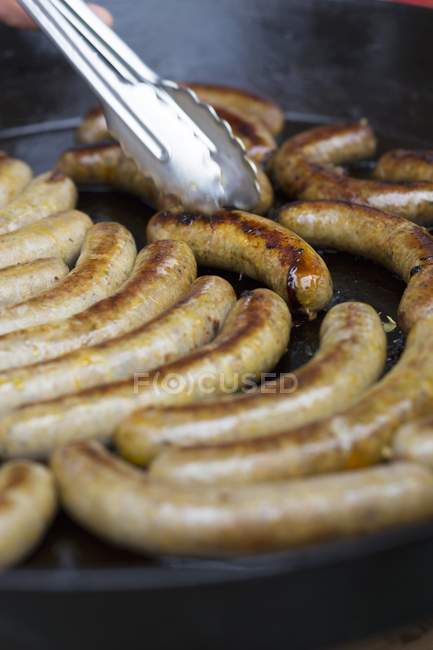 Roasted Sausages in frying pan — Stock Photo