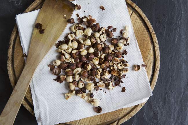 Roasted hazelnuts on paper — Stock Photo