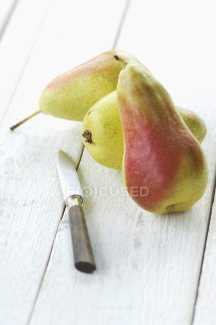 Pears and peeling knife — Stock Photo