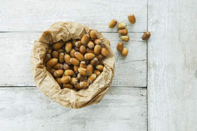 Paper bag of hazelnuts — Stock Photo