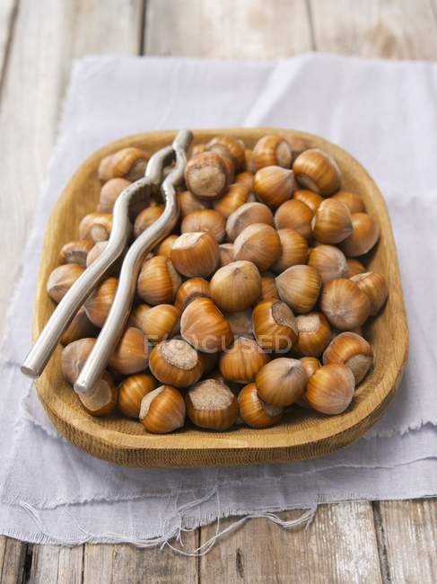 Hazelnuts in a wooden bowl — Stock Photo