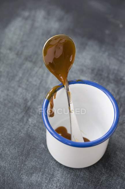Caramel cream on spoon — Stock Photo
