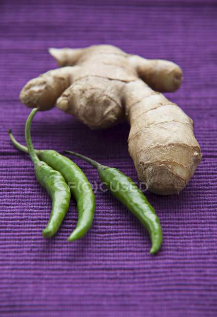 Root ginger and green chilli peppers — Stock Photo
