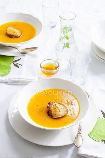 Pumpkin and apple soup in white bowl — Stock Photo