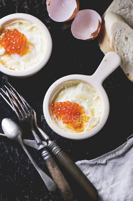 Baked eggs with caviar — Stock Photo