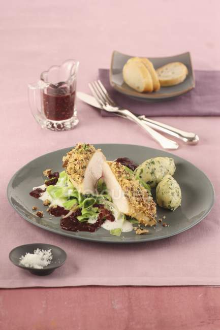 Closeup view of roasted breast with a pecan nut crust on cherry sauce, creamy cabbage and herb semolina dumplings — Stock Photo