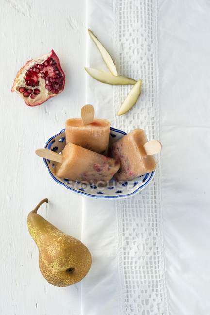 Pear ice lollies with pomegranate seeds — Stock Photo