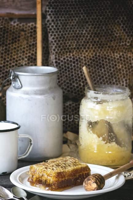 Honeycomb with honey spoon — Stock Photo