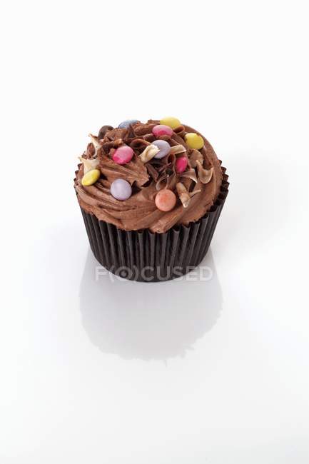Cupcake decorated with chocolate beans — Stock Photo