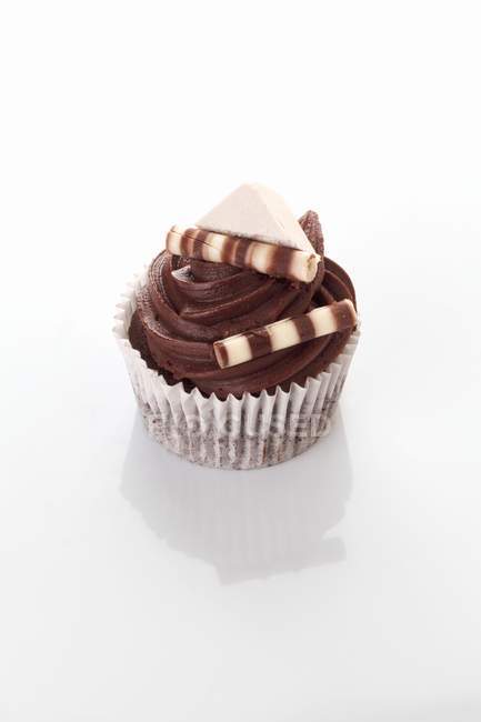 Cupcake decorated with chocolate sticks — Stock Photo