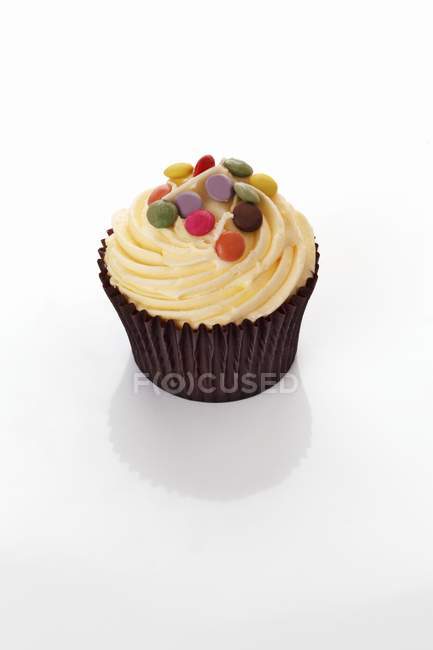 Cupcake with colored chocolate beans — Stock Photo