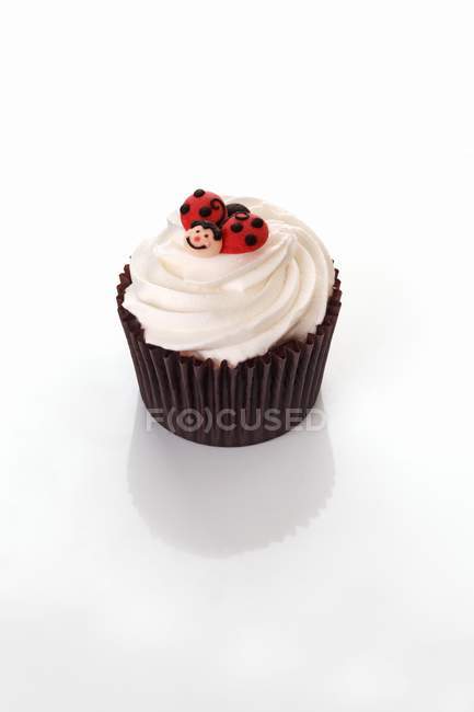 Cupcake decorated with ladybird figure — Stock Photo