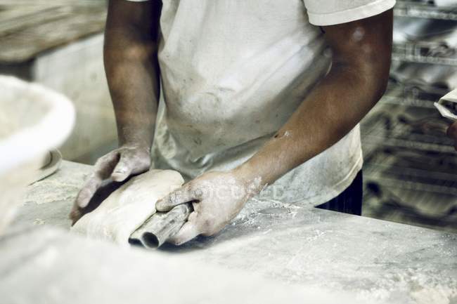 Baker kneading bread — Stock Photo